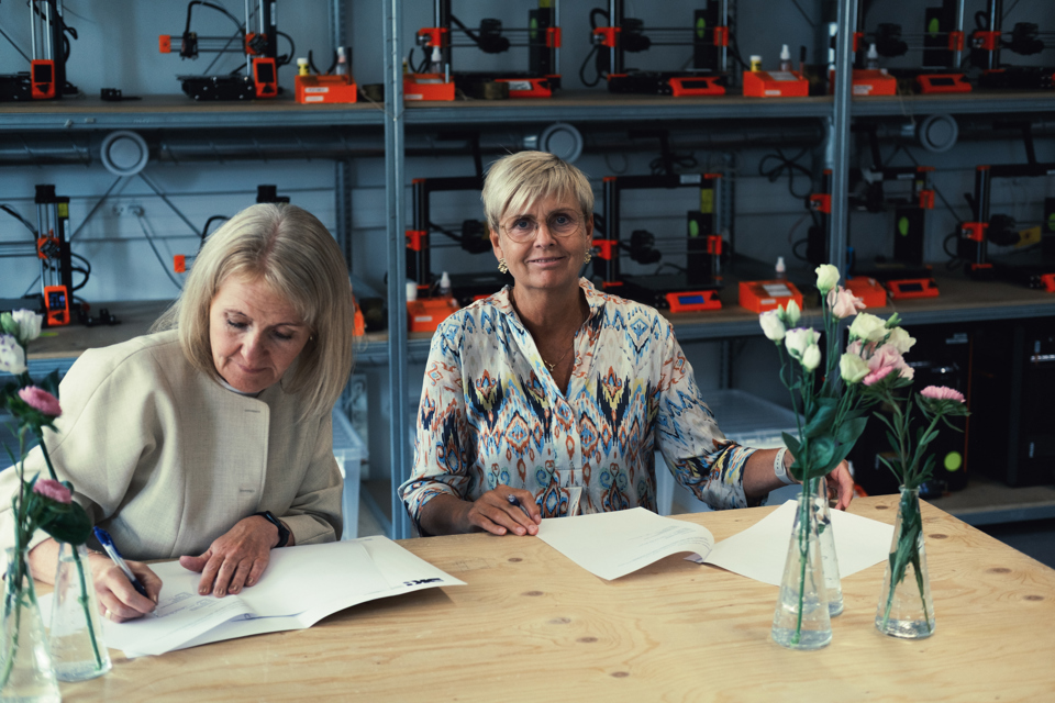 Carina Christensen (til venstre), rektor på Designskolen Kolding og Inge Bendixen, vicedirektør i Syddansk Sundhedsinnovation underskriver 17. august 2026 den treårige partnerskabsaftale.